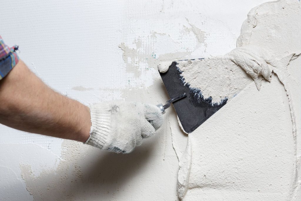 Plastering a wall with a trowel