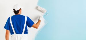 Professional painter that's painting wall blue