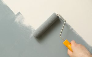Person painting wall