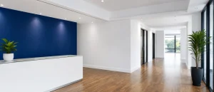 Clean commercial corridor with freshly painted white walls and a subtle blue accent.